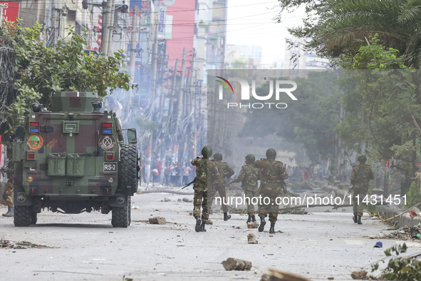 Bangladeshi military force soldiers are patrolling a street during a nationwide curfew in Dhaka, Bangladesh, on July 20, 2024. 