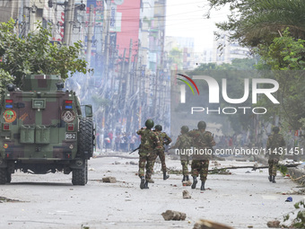 Bangladeshi military force soldiers are patrolling a street during a nationwide curfew in Dhaka, Bangladesh, on July 20, 2024. (