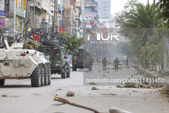 Bangladeshi military force soldiers are patrolling a street during a nationwide curfew in Dhaka, Bangladesh, on July 20, 2024. 