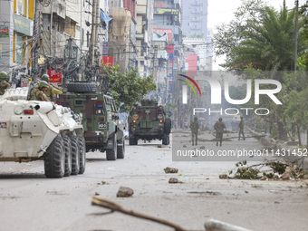 Bangladeshi military force soldiers are patrolling a street during a nationwide curfew in Dhaka, Bangladesh, on July 20, 2024. (