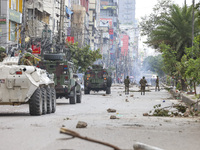 Bangladeshi military force soldiers are patrolling a street during a nationwide curfew in Dhaka, Bangladesh, on July 20, 2024. (