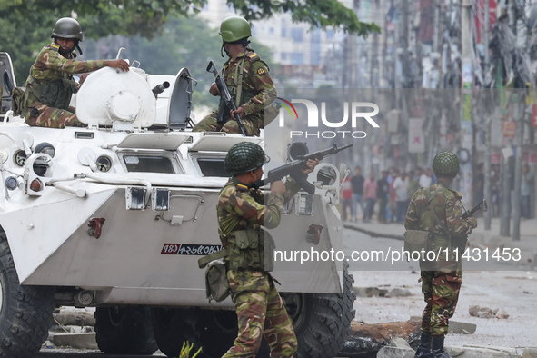 Bangladeshi military force soldiers are patrolling a street during a nationwide curfew in Dhaka, Bangladesh, on July 20, 2024. 