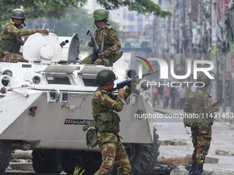 Bangladeshi military force soldiers are patrolling a street during a nationwide curfew in Dhaka, Bangladesh, on July 20, 2024. (