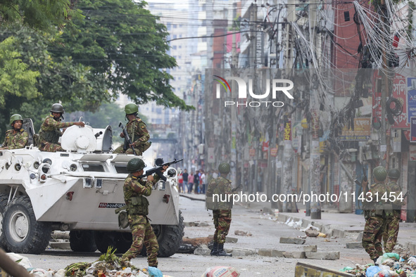 Bangladeshi military force soldiers are patrolling a street during a nationwide curfew in Dhaka, Bangladesh, on July 20, 2024. 