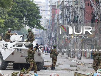 Bangladeshi military force soldiers are patrolling a street during a nationwide curfew in Dhaka, Bangladesh, on July 20, 2024. (