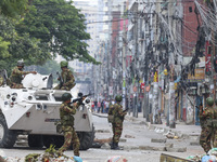 Bangladeshi military force soldiers are patrolling a street during a nationwide curfew in Dhaka, Bangladesh, on July 20, 2024. (