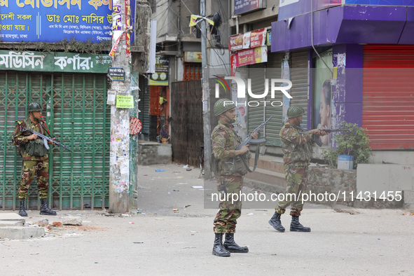 Bangladeshi military force soldiers are patrolling a street during a nationwide curfew in Dhaka, Bangladesh, on July 20, 2024. 