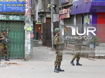 Bangladeshi military force soldiers are patrolling a street during a nationwide curfew in Dhaka, Bangladesh, on July 20, 2024. (