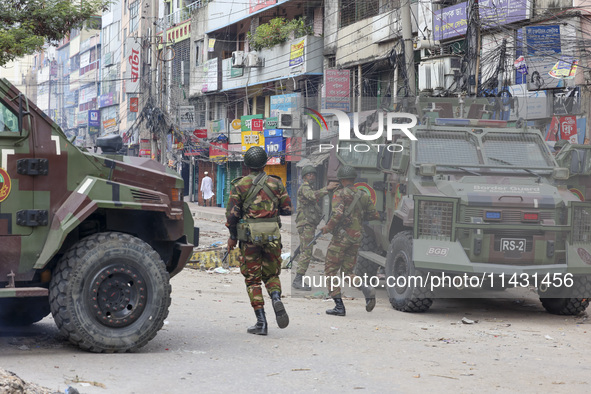 Bangladeshi military force soldiers are patrolling a street during a nationwide curfew in Dhaka, Bangladesh, on July 20, 2024. 