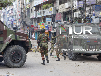 Bangladeshi military force soldiers are patrolling a street during a nationwide curfew in Dhaka, Bangladesh, on July 20, 2024. (