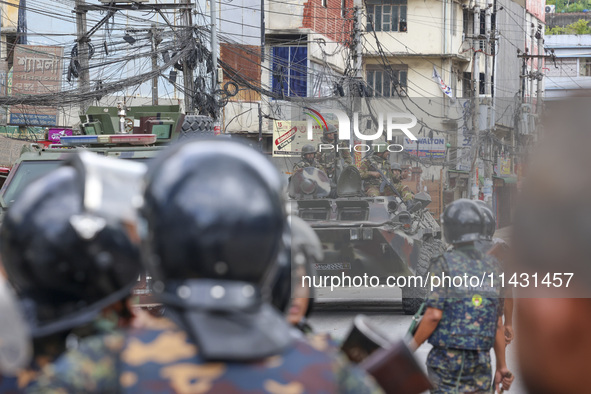 Bangladeshi military force soldiers are patrolling a street during a nationwide curfew in Dhaka, Bangladesh, on July 20, 2024. 