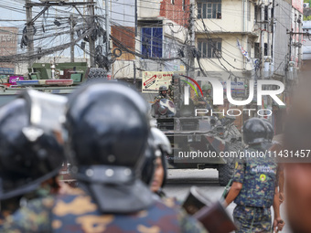 Bangladeshi military force soldiers are patrolling a street during a nationwide curfew in Dhaka, Bangladesh, on July 20, 2024. (