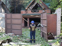 A rescuer is standing at the gate in a residential area in the city centre hit by a Russian guided bomb in Kharkiv, Ukraine, on July 24, 202...