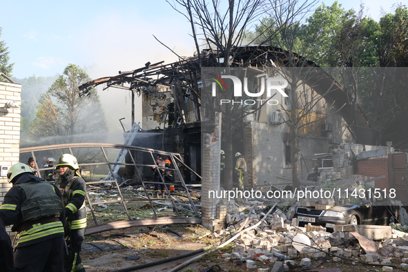 Firefighters are dealing with the damage done to a residential area in the city centre hit by a Russian guided bomb in Kharkiv, Ukraine, on...