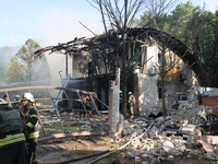 Firefighters are dealing with the damage done to a residential area in the city centre hit by a Russian guided bomb in Kharkiv, Ukraine, on...