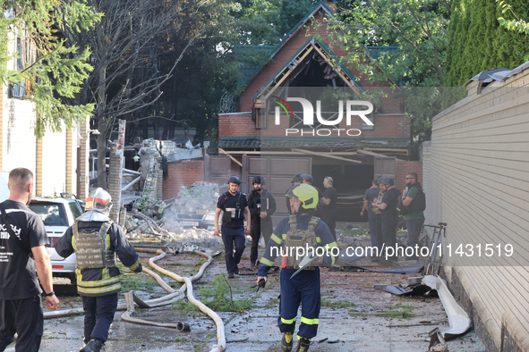 Firefighters are dealing with the damage done to a residential area in the city center hit by a Russian guided bomb in Kharkiv, Ukraine, on...