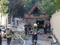 Firefighters are dealing with the damage done to a residential area in the city center hit by a Russian guided bomb in Kharkiv, Ukraine, on...