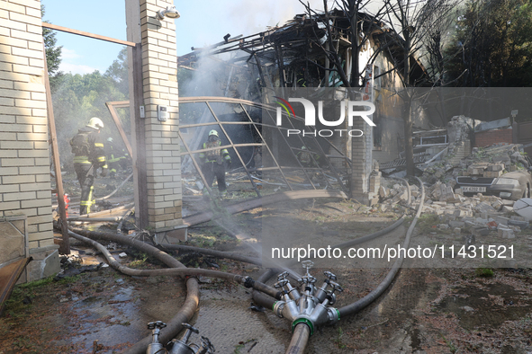 Firefighters are working in a residential area hit by a Russian guided bomb in central Kharkiv, northeastern Ukraine, on July 24, 2024. NO U...