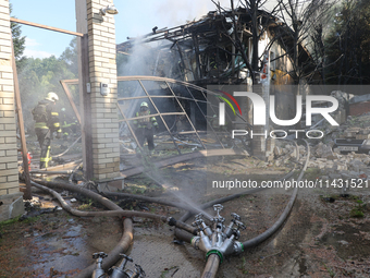 Firefighters are working in a residential area hit by a Russian guided bomb in central Kharkiv, northeastern Ukraine, on July 24, 2024. NO U...