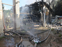 Firefighters are working in a residential area hit by a Russian guided bomb in central Kharkiv, northeastern Ukraine, on July 24, 2024. NO U...