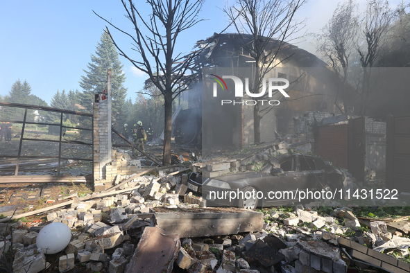 A car is being crushed by rubble in a residential area hit by a Russian guided bomb in central Kharkiv, Ukraine, on July 24, 2024. NO USE RU...