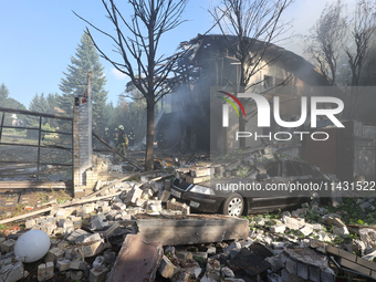 A car is being crushed by rubble in a residential area hit by a Russian guided bomb in central Kharkiv, Ukraine, on July 24, 2024. NO USE RU...