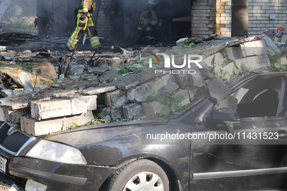 A car is being crushed by rubble in a residential area hit by a Russian guided bomb in central Kharkiv, Ukraine, on July 24, 2024. NO USE RU...