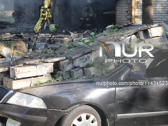 A car is being crushed by rubble in a residential area hit by a Russian guided bomb in central Kharkiv, Ukraine, on July 24, 2024. NO USE RU...