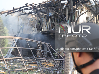 Firefighters are dealing with the damage done to a residential area in the city center hit by a Russian guided bomb in Kharkiv, Ukraine, on...