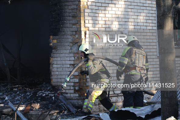 Firefighters are working in a residential area hit by a Russian guided bomb in central Kharkiv, northeastern Ukraine, on July 24, 2024. NO U...