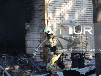 Firefighters are working in a residential area hit by a Russian guided bomb in central Kharkiv, northeastern Ukraine, on July 24, 2024. NO U...