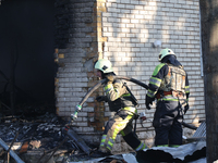 Firefighters are working in a residential area hit by a Russian guided bomb in central Kharkiv, northeastern Ukraine, on July 24, 2024. NO U...