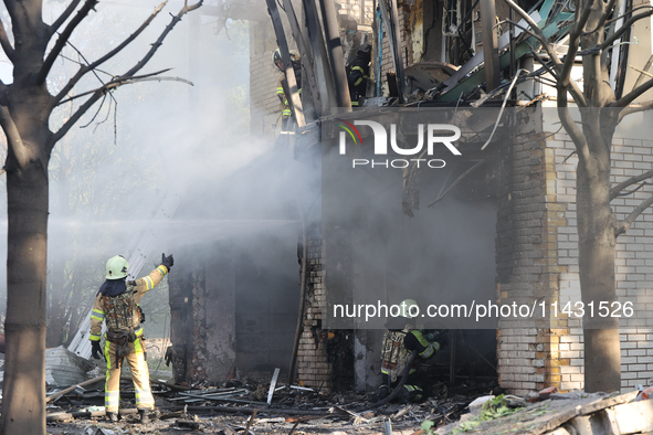 Firefighters are dealing with the damage done to a residential area in the city center hit by a Russian guided bomb in Kharkiv, Ukraine, on...