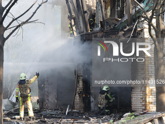 Firefighters are dealing with the damage done to a residential area in the city center hit by a Russian guided bomb in Kharkiv, Ukraine, on...