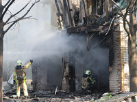 Firefighters are dealing with the damage done to a residential area in the city center hit by a Russian guided bomb in Kharkiv, Ukraine, on...