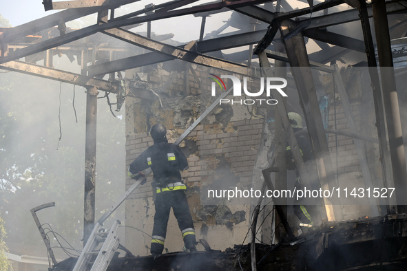 Firefighters are dealing with the damage done to a residential area in the city center hit by a Russian guided bomb in Kharkiv, Ukraine, on...