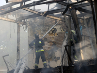 Firefighters are dealing with the damage done to a residential area in the city center hit by a Russian guided bomb in Kharkiv, Ukraine, on...