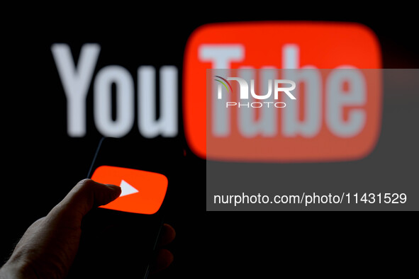 The YouTube play icon is being displayed on a smartphone, with YouTube in the background, in this photo illustration in Brussels, Belgium, o...