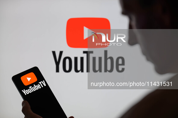 The YouTube TV logo is being displayed on a smartphone, with YouTube in the background, in this photo illustration in Brussels, Belgium, on...