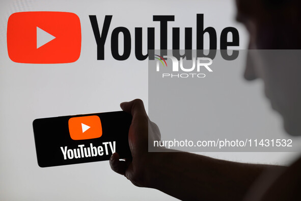 The YouTube TV logo is being displayed on a smartphone, with YouTube in the background, in this photo illustration in Brussels, Belgium, on...