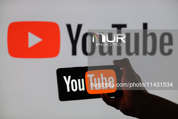 The YouTube logo is being displayed on a smartphone, with YouTube in the background, in this photo illustration in Brussels, Belgium, on Jul...