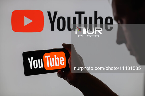 The YouTube logo is being displayed on a smartphone, with YouTube in the background, in this photo illustration in Brussels, Belgium, on Jul...