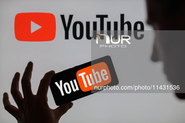 The YouTube logo is being displayed on a smartphone, with YouTube in the background, in this photo illustration in Brussels, Belgium, on Jul...