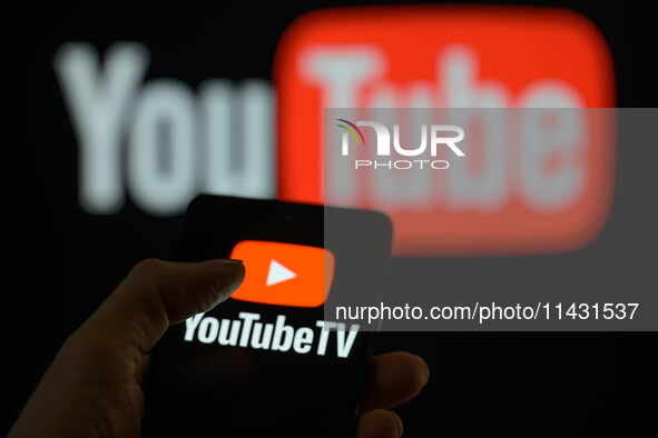 The YouTube TV logo is being displayed on a smartphone, with YouTube in the background, in this photo illustration in Brussels, Belgium, on...