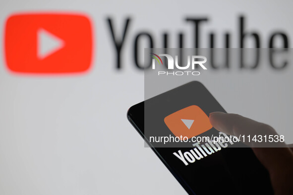 The YouTube TV logo is being displayed on a smartphone, with YouTube in the background, in this photo illustration in Brussels, Belgium, on...