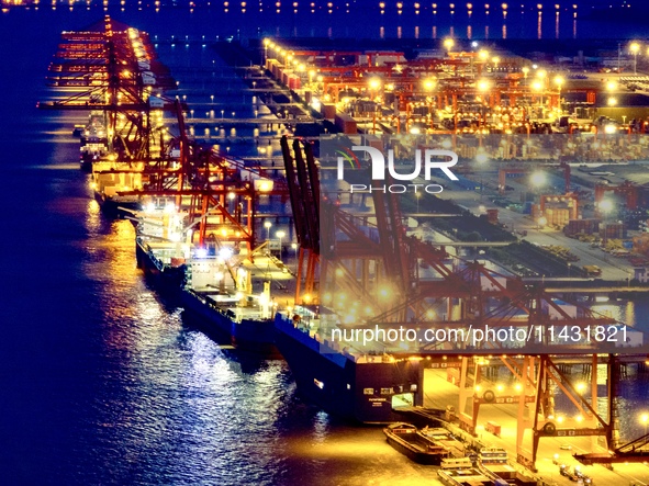 The container terminal of Taicang Port Phase 4 is being illuminated in Suzhou, Jiangsu province, China, on the evening of July 9, 2024. 