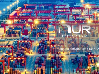 The container terminal of Taicang Port Phase 4 is being illuminated in Suzhou, Jiangsu province, China, on the evening of July 9, 2024. (