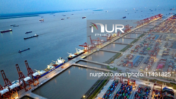 The container terminal of Taicang Port Phase 4 is being illuminated in Suzhou, Jiangsu province, China, on the evening of July 9, 2024. 