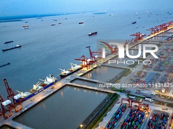 The container terminal of Taicang Port Phase 4 is being illuminated in Suzhou, Jiangsu province, China, on the evening of July 9, 2024. (