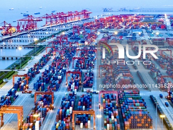 The container terminal of Taicang Port Phase 4 is being illuminated in Suzhou, Jiangsu province, China, on the evening of July 9, 2024. (